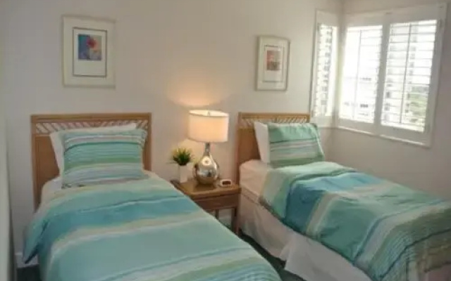 photo 2 of Deluxe Beachfront Condo Located in Prestigious Resort with Pool and Hot Tub by RedAwning